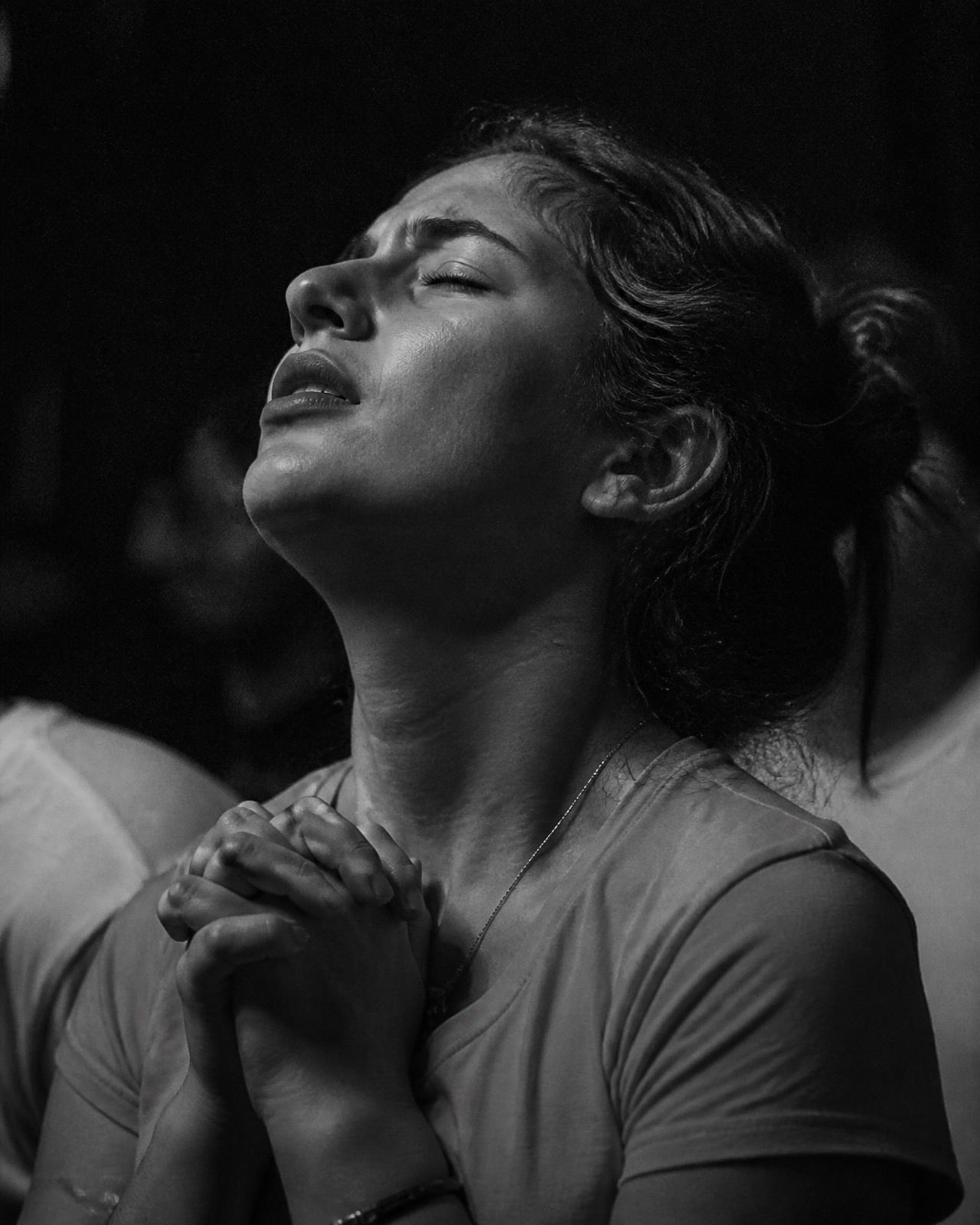 A woman praying with her eyes closed